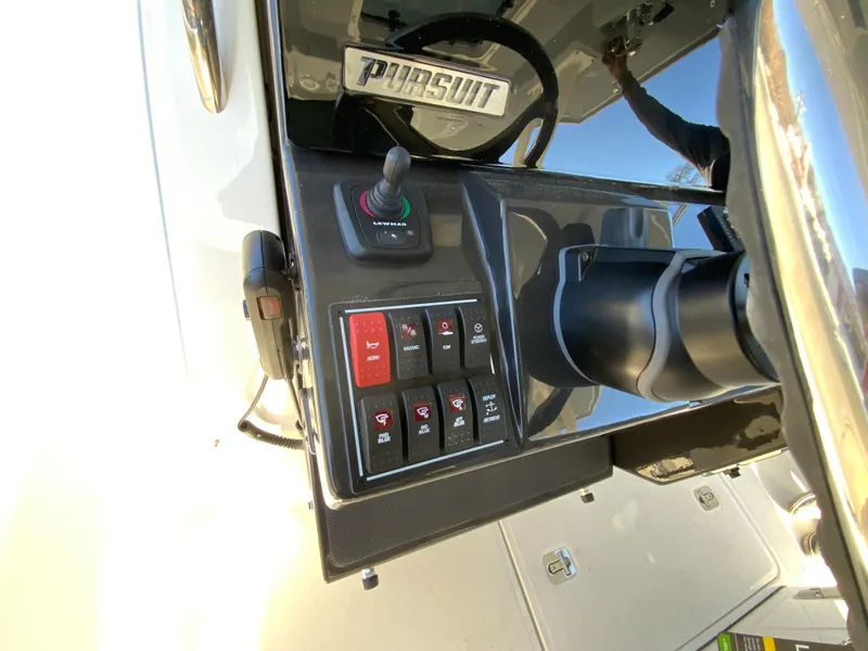 Slide: The Image of Control panel of 2024 Pursuit S 328 Sport boat with steering wheel and switches. - 47