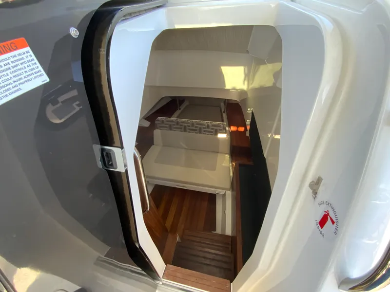 Slide: The Image of 2024 Pursuit S 328 Sport cabin interior with wooden flooring and seating area. - 48