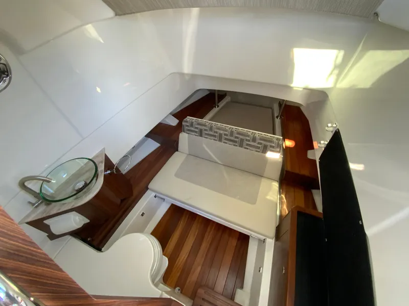 Slide: The Image of 2024 Pursuit S 328 Sport cabin interior with wooden flooring and seating area. - 49