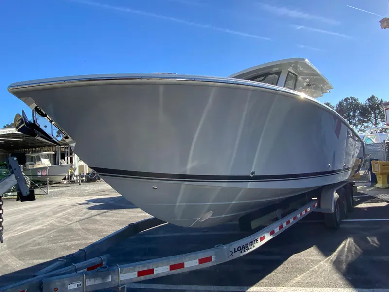 Slide: The Image of 2024 Pursuit S 328 Sport boat on trailer under clear blue sky. - 6
