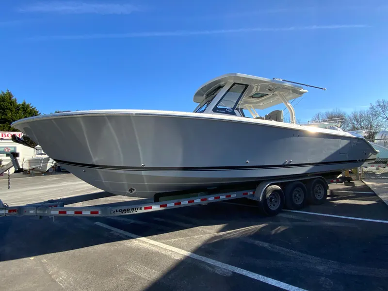 Slide: The Image of 2024 Pursuit S 328 Sport boat on a trailer in a parking lot. - 7