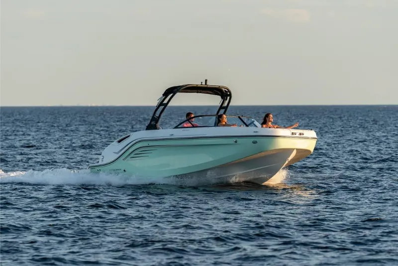 Slide: The Image of 2023 Bayliner DX2200 boat cruising on open water. - 1