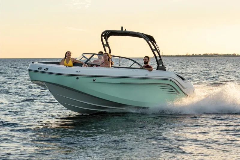 Slide: The Image of 2023 Bayliner DX2200 boat cruising on open water at sunset. - 3