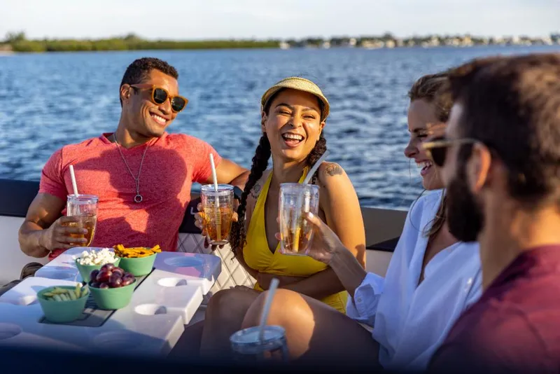 Slide: The Image of Friends enjoying drinks on a 2023 Bayliner DX2200 boat. - 47