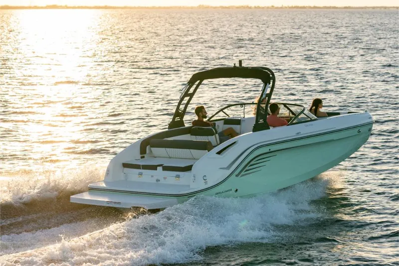 Slide: The Image of 2023 Bayliner DX2200 boat cruising on open water at sunset. - 6