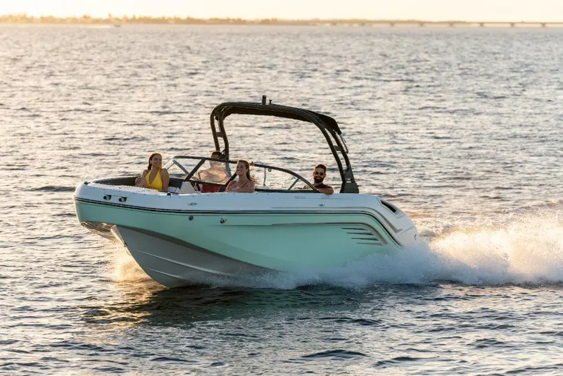 Slide: The Image of 2023 Bayliner DX2200 boat cruising on open water with passengers. - 7