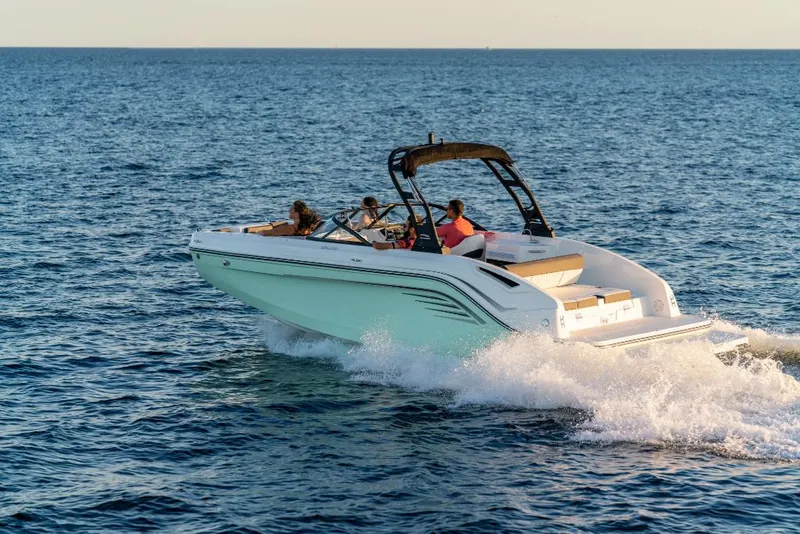 Slide: The Image of 2023 Bayliner DX2200 boat cruising on open water. - 9