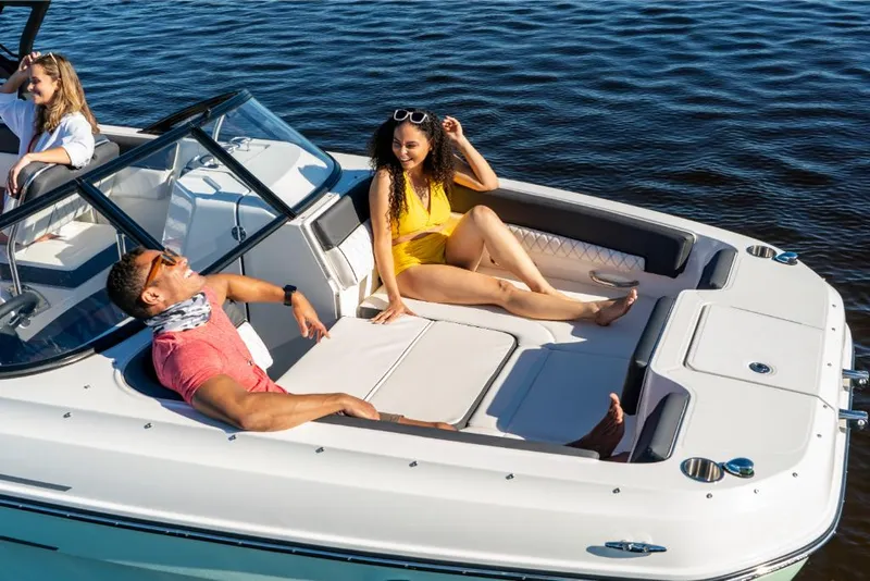 Slide: The Image of 2023 Bayliner DX2250 boat with people relaxing on deck in sunny weather. - 13