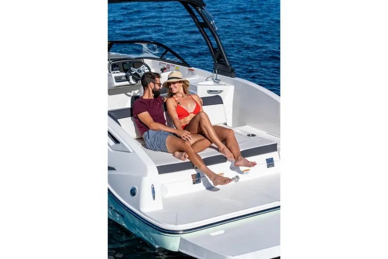 Slide: The Image of Couple relaxing on a 2023 Bayliner DX2250 boat in the ocean. - 21