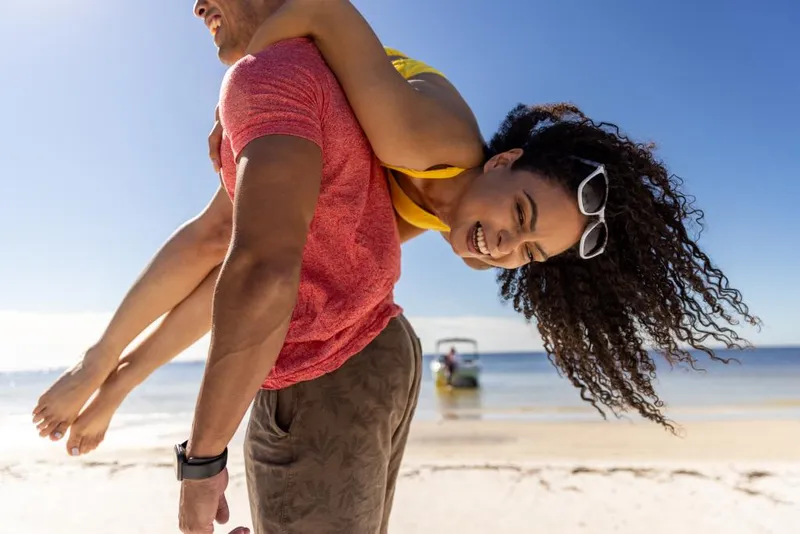 Slide: The Image of A couple enjoying a beach day with a 2023 Bayliner DX2250 boat in the background. - 42