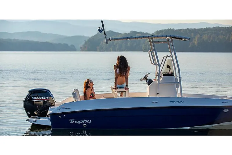 Slide: The Image of 2023 Bayliner T18 boat on a serene lake with two people enjoying the view. - 3
