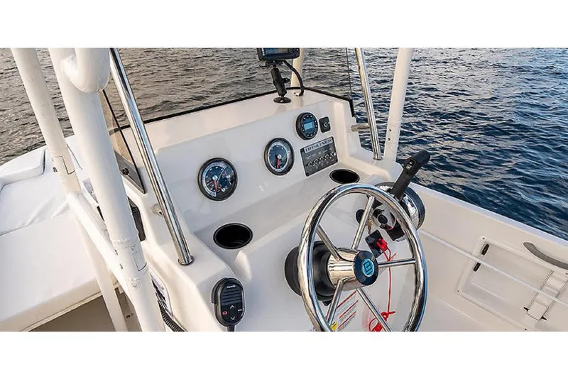Slide: The Image of 2023 Bayliner T18 boat dashboard with steering wheel and gauges. - 4