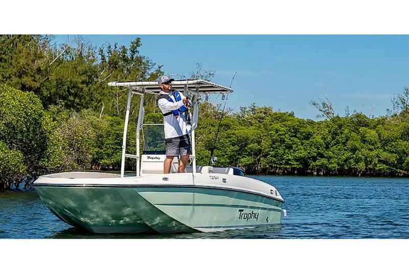 Slide: The Image of 2023 Bayliner T21 boat on water with person fishing. - 0
