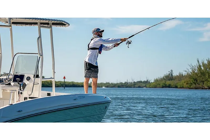 Slide: The Image of Man fishing on a 2023 Bayliner T21 boat in a scenic waterway. - 3