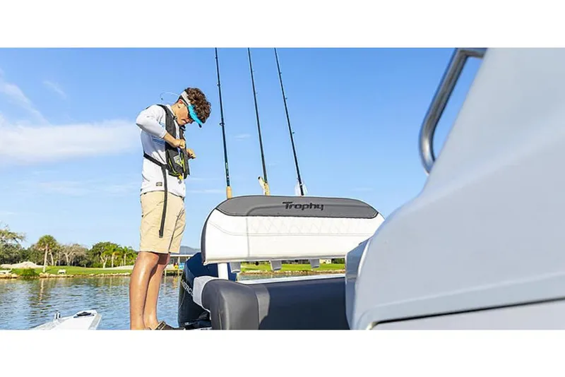 Slide: The Image of 2023 Bayliner T20 CC boat with a person preparing fishing gear. - 5