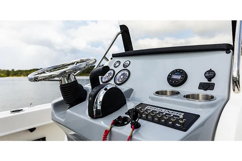Slide: The Image of 2023 Bayliner T20 CC boat dashboard with steering wheel and control panel. - 6