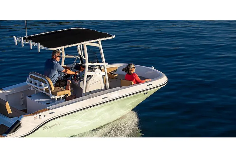 Slide: The Image of 2023 Bayliner T20 CX boat cruising on water with two passengers. - 2