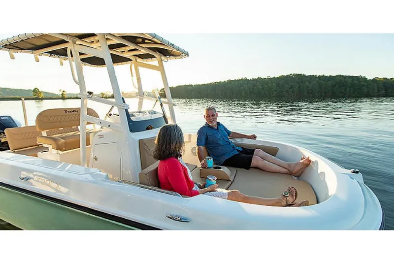 Slide: The Image of 2023 Bayliner T20 CX boat with people relaxing on deck, scenic lake background. - 4