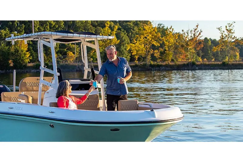 Slide: The Image of 2023 Bayliner T20 CX boat on a lake with two people enjoying drinks. - 5