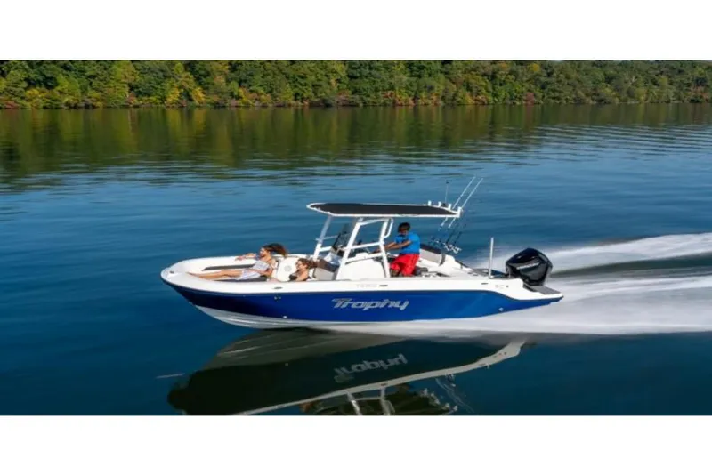 Slide: The Image of 2023 Bayliner T22 CC boat cruising on a calm lake with passengers. - 5