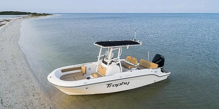 Slide: The Image of 2023 Bayliner T22 CX boat anchored on a serene beach. - 6