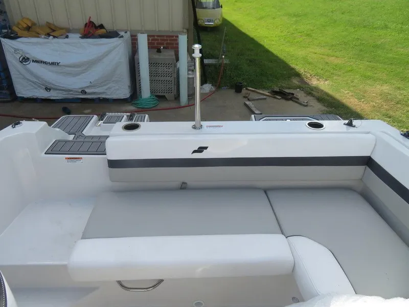 Slide: The Image of 2023 Starcraft SVX 191 OB boat interior with cushioned seating and cup holders. - 12