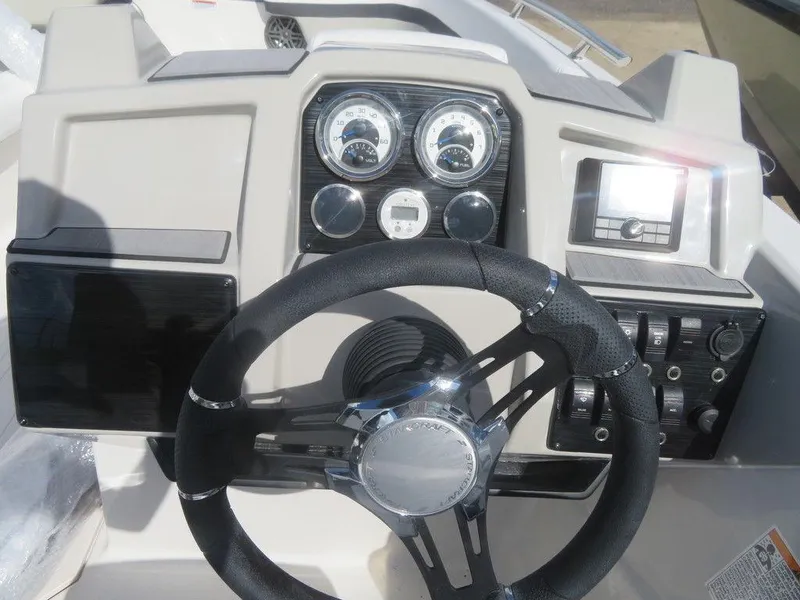 Slide: The Image of 2023 Starcraft SVX 191 OB boat dashboard with steering wheel and gauges. - 16