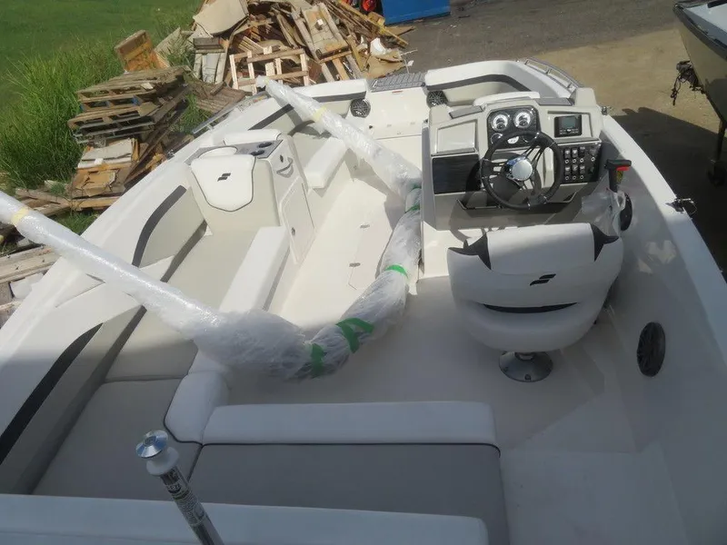 Slide: The Image of 2023 Starcraft SVX 191 OB boat interior with steering console and seating. - 17