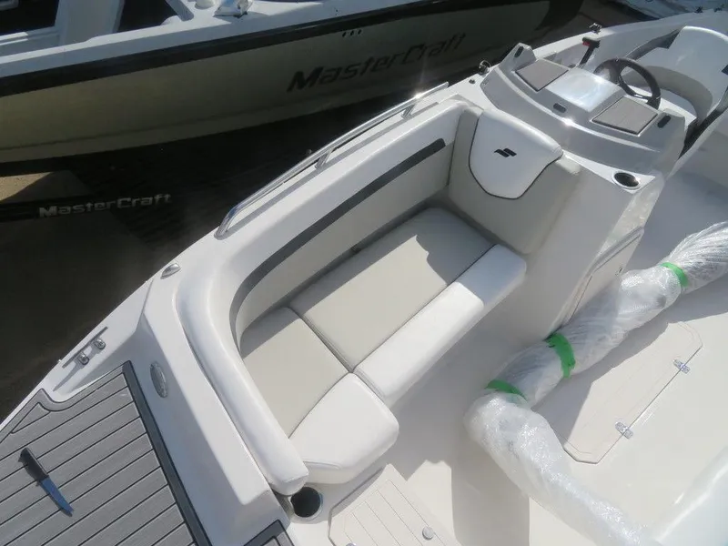 Slide: The Image of 2023 Starcraft SVX 191 OB boat interior with cushioned seating and steering console. - 6