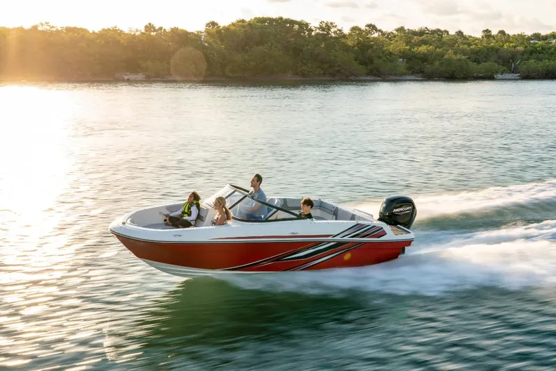 Slide: The Image of 2023 Bayliner VR4 Bowrider speeding on a serene lake at sunset. - 12