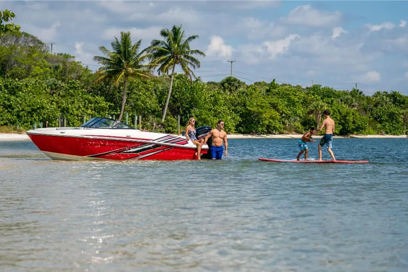 Slide: The Image of 2023 Bayliner VR4 Bowrider boat with family enjoying water activities near a tropical beach. - 29