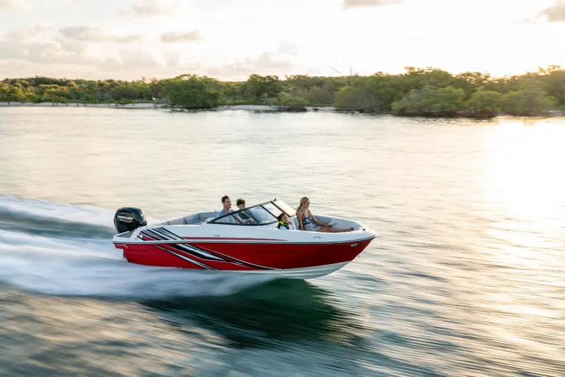 Slide: The Image of 2023 Bayliner VR4 Bowrider speeding on a serene lake at sunset. - 8