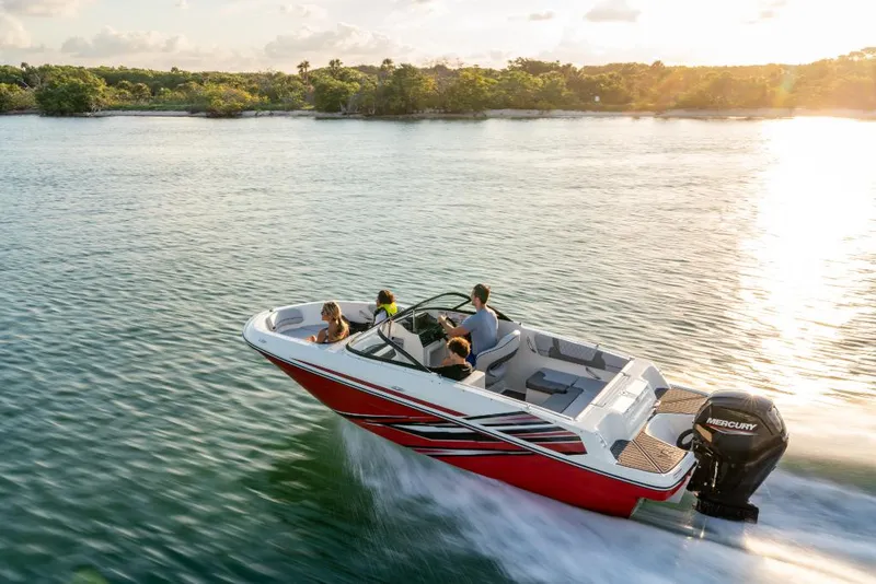 Slide: The Image of 2023 Bayliner VR4 Outboard boat cruising on a lake at sunset. - 11
