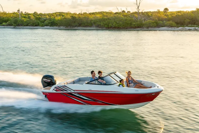 Slide: The Image of 2023 Bayliner VR4 Outboard speeding on water with passengers. - 2