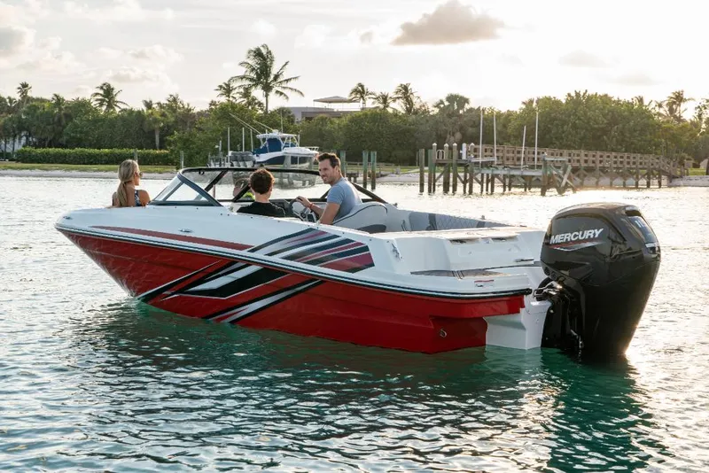 Slide: The Image of 2023 Bayliner VR4 Outboard boat cruising on water with three passengers. - 20