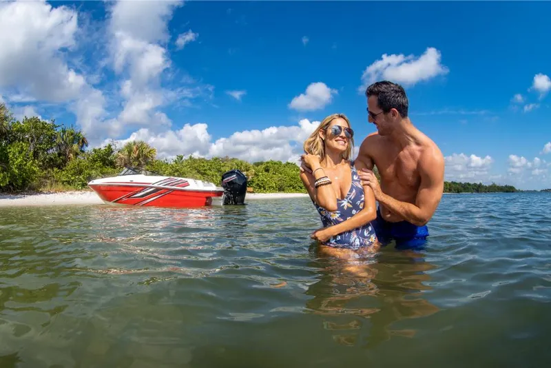 Slide: The Image of Couple enjoying water near 2023 Bayliner VR4 Outboard boat on a sunny day. - 25