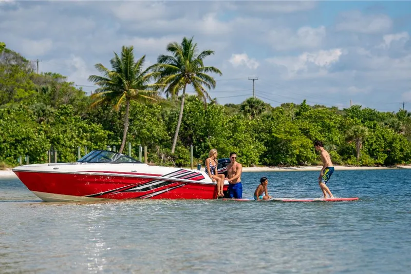 Slide: The Image of 2023 Bayliner VR4 Outboard boat with people enjoying water activities near a tropical beach. - 29