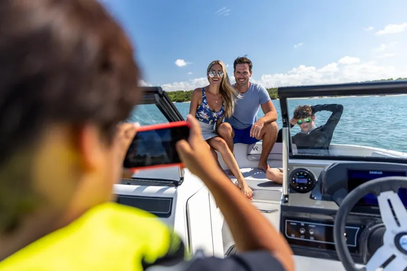 Slide: The Image of Family enjoying a day on a 2023 Bayliner VR4 Outboard boat. - 33