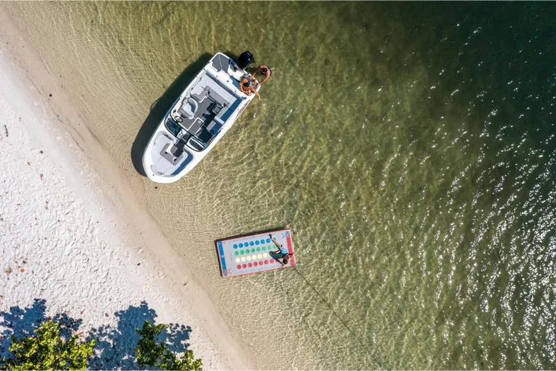 Slide: The Image of Aerial view of a 2023 Bayliner VR4 Outboard boat anchored on a sandy beach. - 38