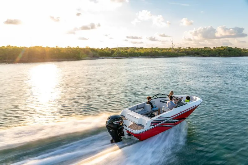 Slide: The Image of 2023 Bayliner VR4 Outboard boat cruising on a serene lake at sunset. - 5