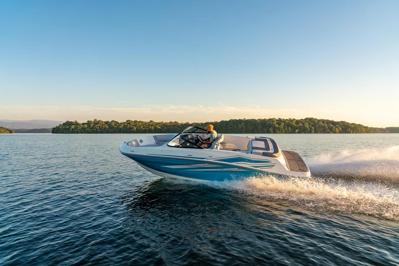 Slide: The Image of 2023 Bayliner VR5 Outboard speeding on a serene lake at sunset. - 0
