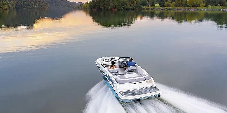 Slide: The Image of 2023 Bayliner VR5 Outboard cruising on a serene lake at sunset. - 3