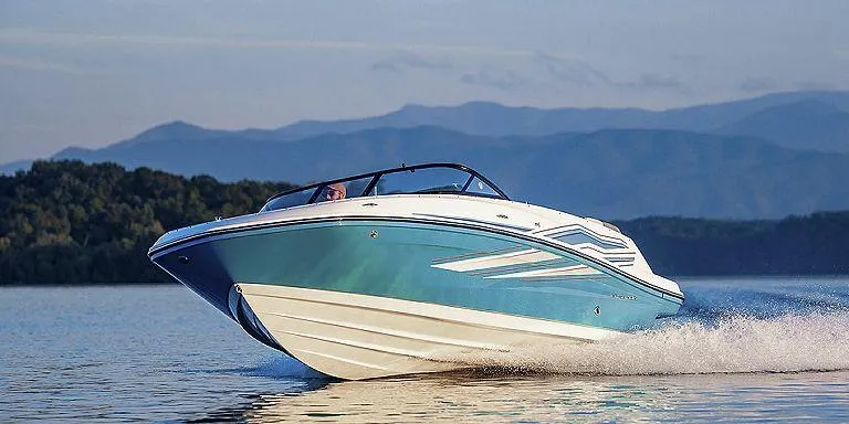 Slide: The Image of 2023 Bayliner VR5 Outboard boat cruising on a lake with mountains in the background. - 4