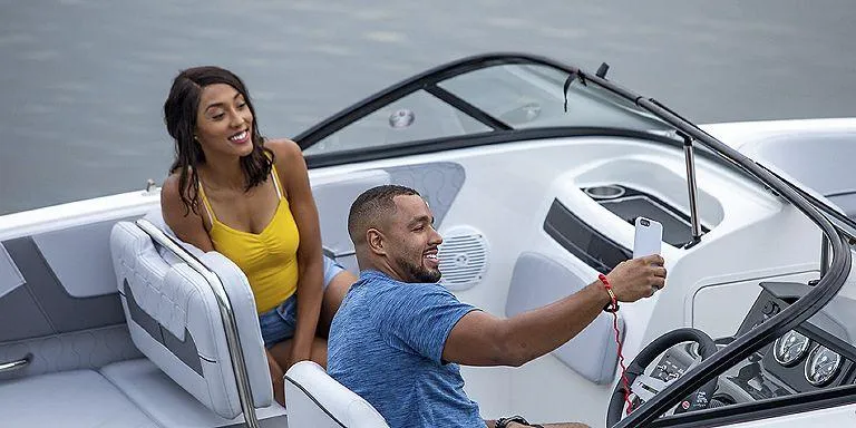 Slide: The Image of Couple enjoying a ride on a 2023 Bayliner VR5 Outboard boat. - 7