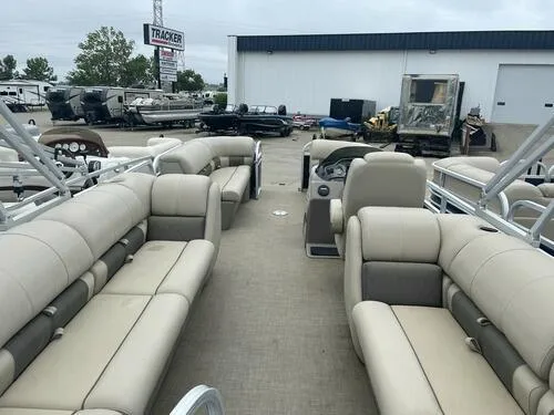 Slide: The Image of 2021 Sun Tracker Party Barge 22 DLX pontoon boat with beige seating at a dealership. - 4