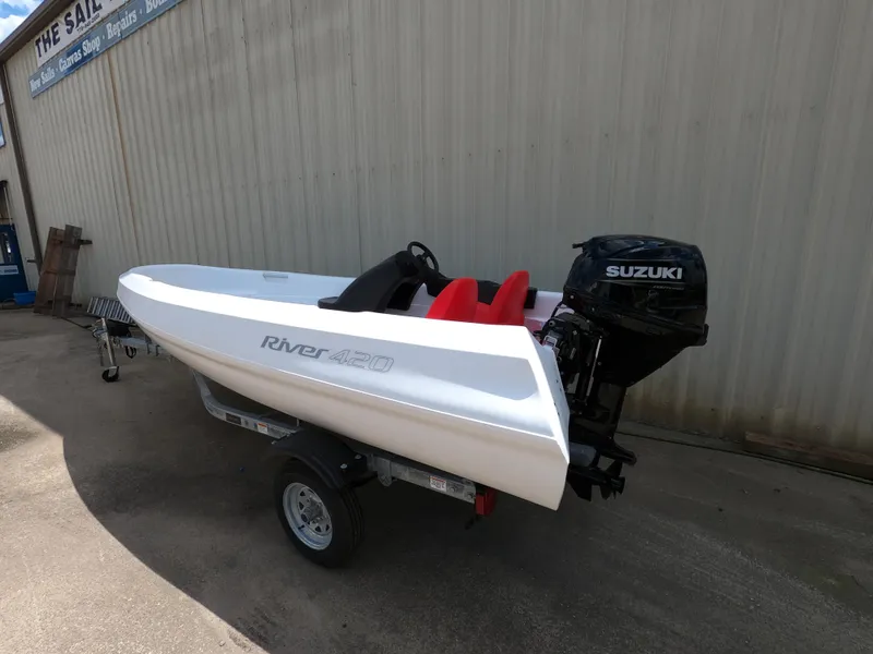 Slide: The Image of 2022 River Boats 420 with Suzuki engine on trailer. - 2