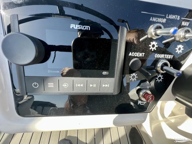 Slide: The Image of Control panel of 2023 Sea Ray SPX 210 boat with audio and light switches. - 11