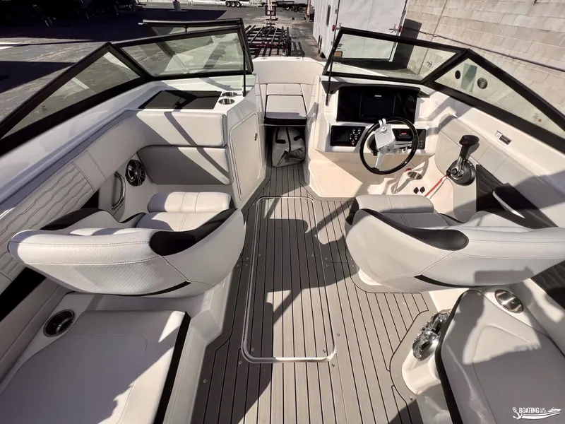 Slide: The Image of 2023 Sea Ray SPX 210 boat interior with modern seating and steering console. - 12
