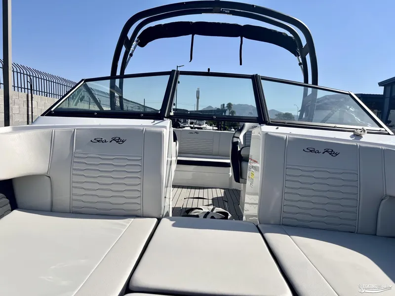 Slide: The Image of 2023 Sea Ray SPX 210 boat interior with sleek white seating and modern design. - 2