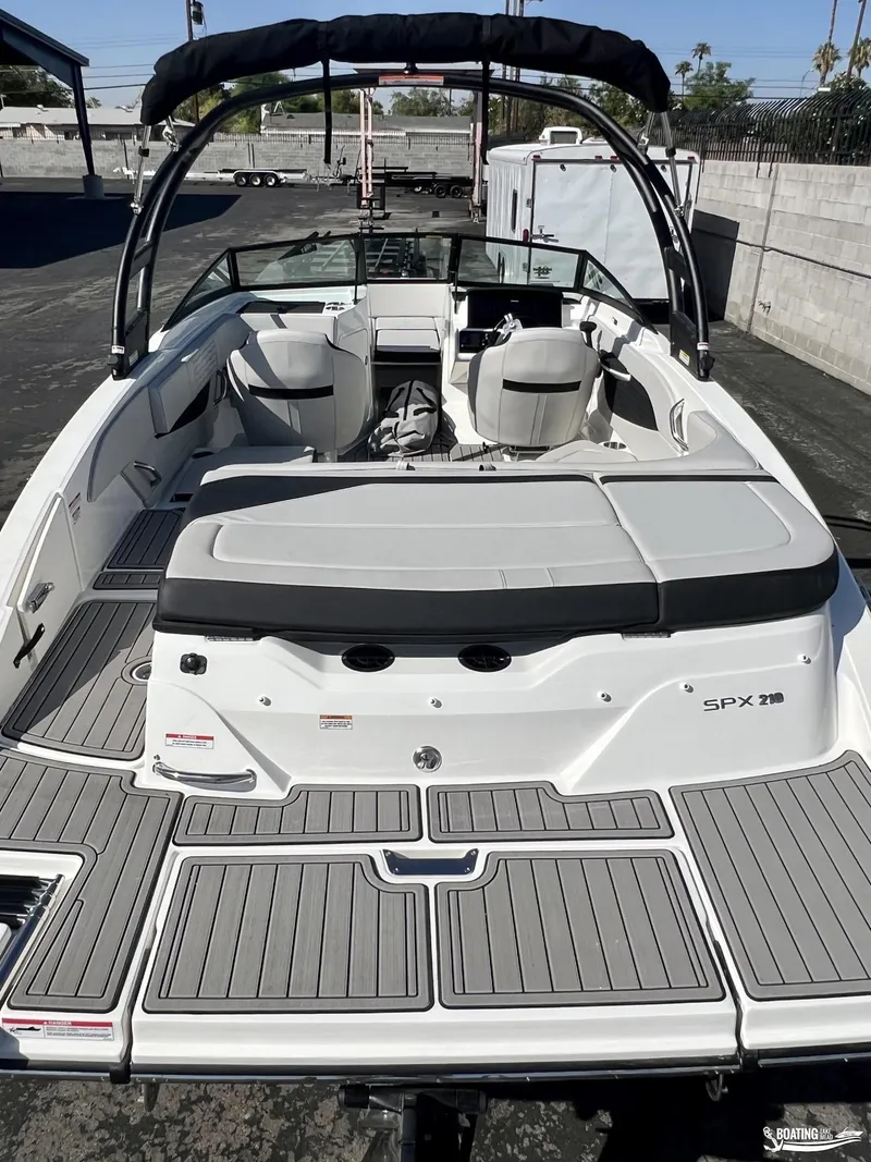Slide: The Image of 2023 Sea Ray SPX 210 boat with spacious seating and sleek design. - 3